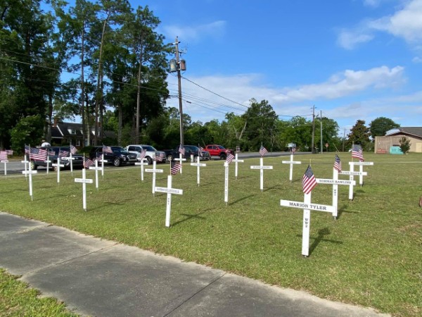 Lawn with rows of Memorial Day memorials on it